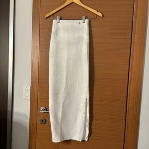 New Maniere De Voir white bedazzled maxi skirt with a side slit. Size 2